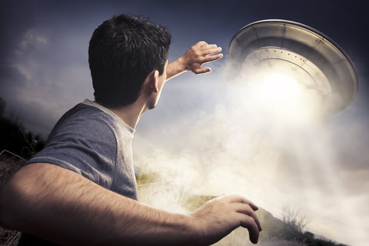 Image shows a man and a flying saucer.