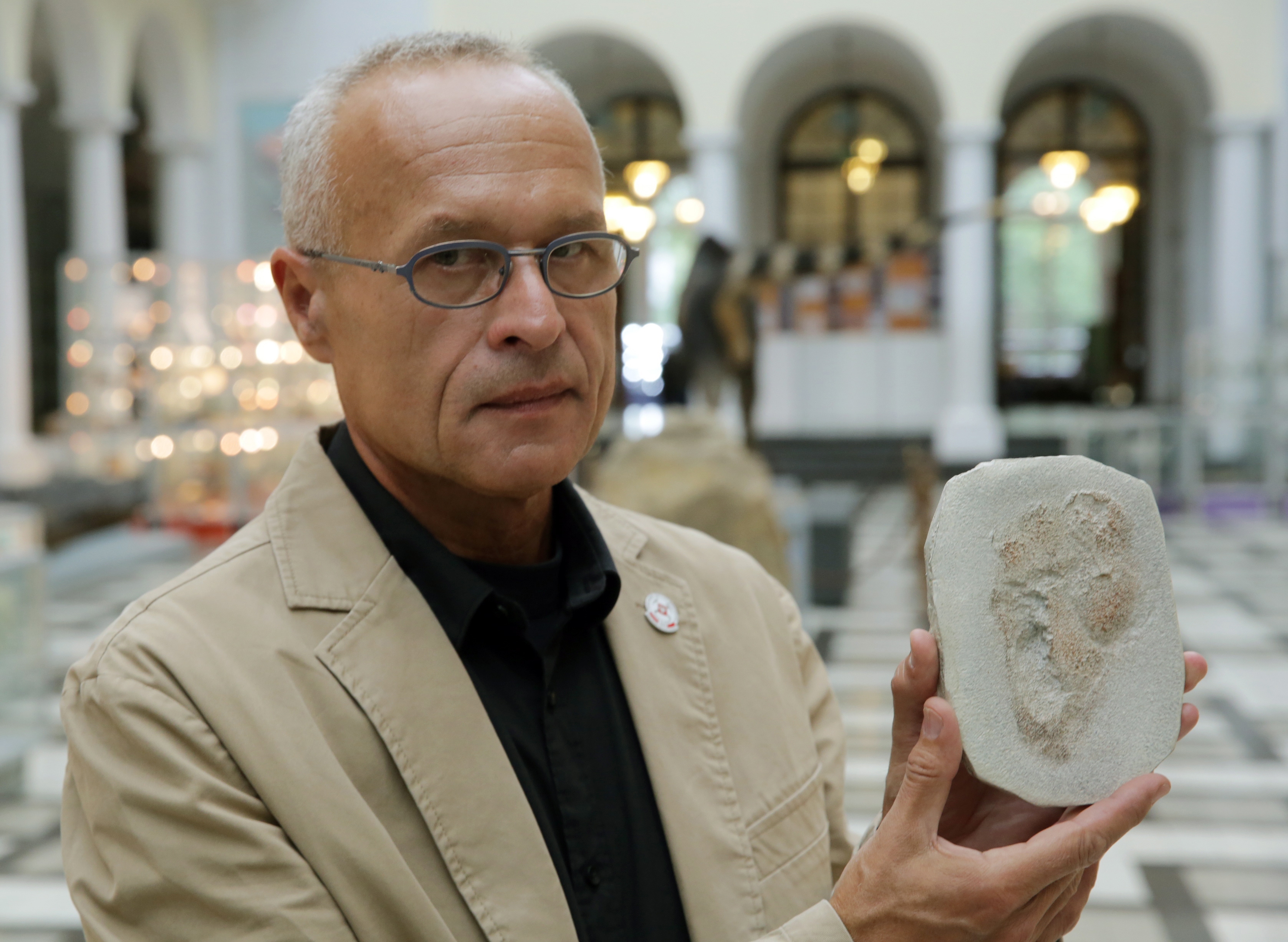 Gerard Gierlinski presents a plaster replica of one of the Trachilos footprints during a press conference in Warsaw, Poland, in September 2017. (Tomasz Gzell/EFE/EPA)