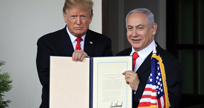 U.S. President Donald Trump and Israel's Prime Minister Benjamin Netanyahu hold up a proclamation recognizing Israel's sovereignty over the Golan Heights as Netanyahu exits the White House from the West Wing in Washington, U.S. March 25, 2019