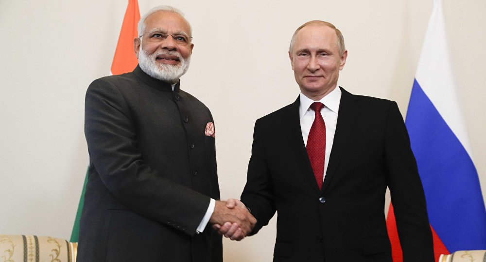 Russian President Vladimir Putin (R) shakes hands with Indian Prime Minister Narendra Modi during a meeting on the sidelines of the St. Petersburg International Economic Forum (SPIEF), Russia