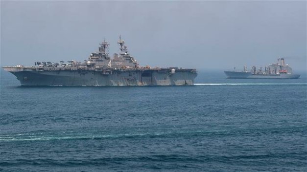 The amphibious assault ship USS Boxer (L) and the fleet replenishment oiler USNS Tippecanoe transit the Persian Gulf following a replenishment at sea off Oman, according to the US Navy in this picture released on July 24, 2019. (Photo via Reuters)